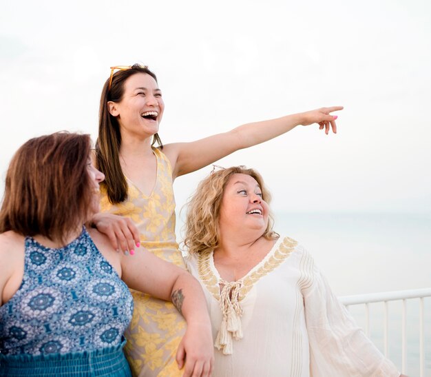 Women in casual clothes pointing in the air