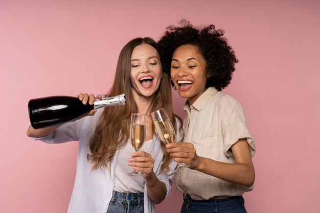 Women celebration with champagne glasses and bottle