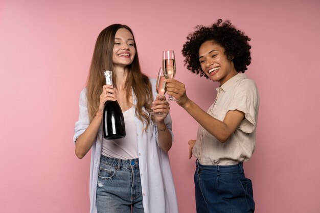 Women celebration with champagne glasses and bottle