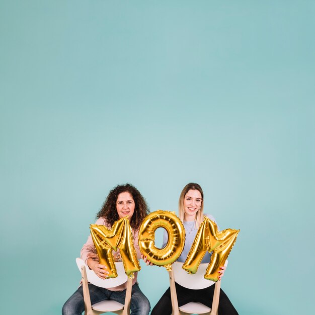 Women on chairs with mom writing