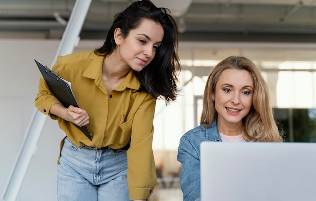 Women checking a work project together