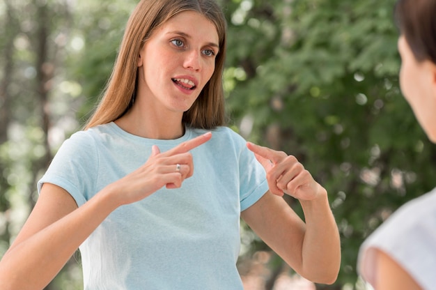 Women communicating with each other by using sign language