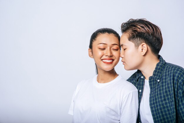 Women couples stand and fragrant cheek.