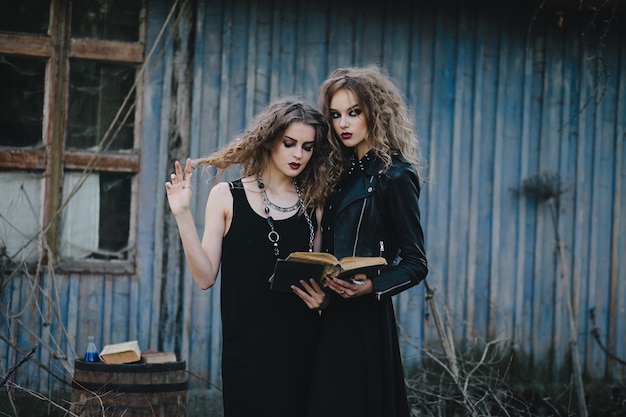 Women disguised as witches in an abandoned house