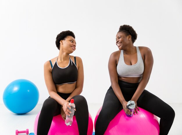 Women doing exercises on fitness ball