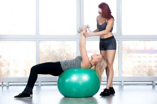 Women doing pilates exercises in gym