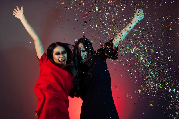 Women dressed as witches with confetti