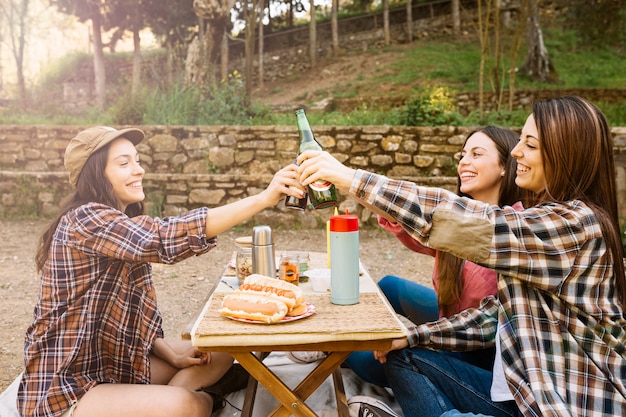 Women drinking beer in nature