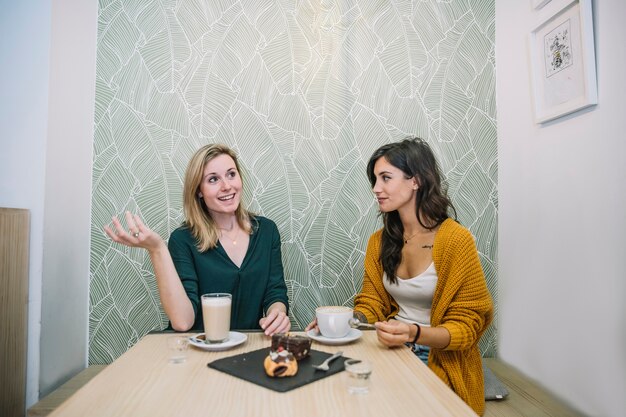 Women enjoying coffee and speaking