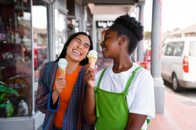 Free photo women enjoying ice cream outside