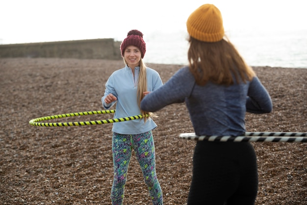 Free photo women exercising with hula hoop circle