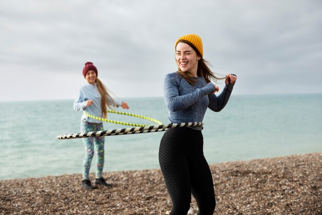 Women exercising with hula hoop circle