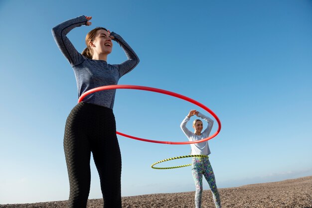 Women exercising with hula hoop circle