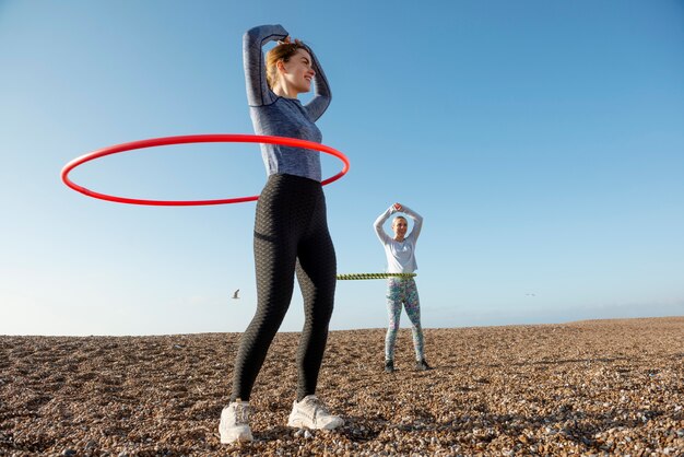 Women exercising with hula hoop circle