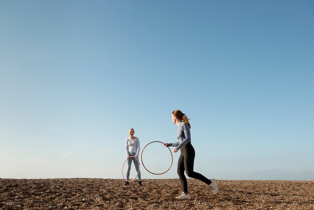 Women exercising with hula hoop circle