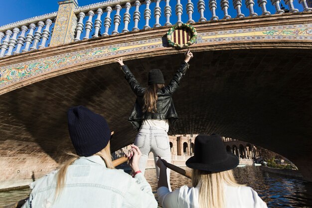 Women floating under bridge