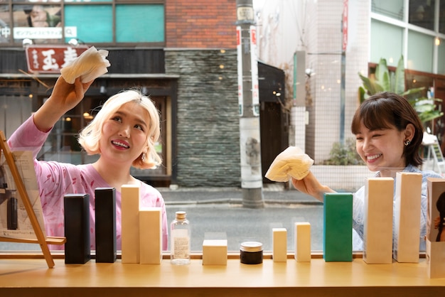 Free photo women getting the display window of a japanese hairdressers ready