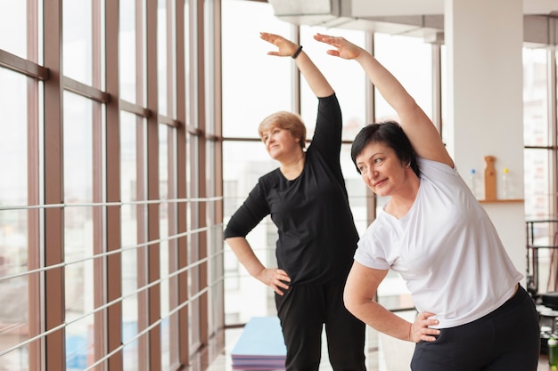 Free photo women at gym stretching