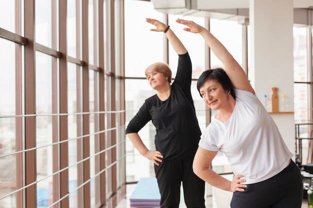 Women at gym stretching