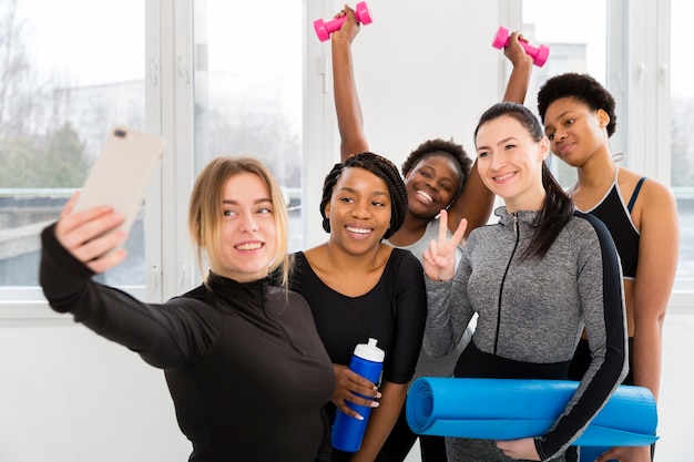 Free photo women at gym taking photos