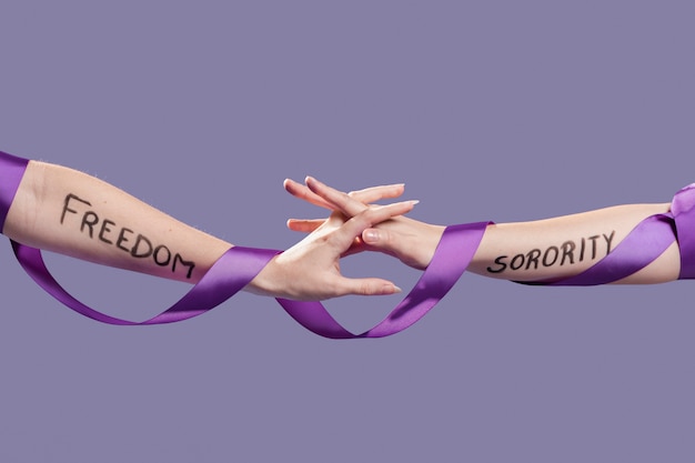 Free photo women hands grasping each other as a sign of sisterhood