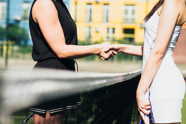 Foto gratuita handshaking delle donne dopo aver giocato una partita di tennis