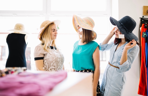 Women in hats looking at each other