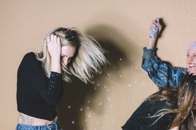 Women having fun with artificial snow