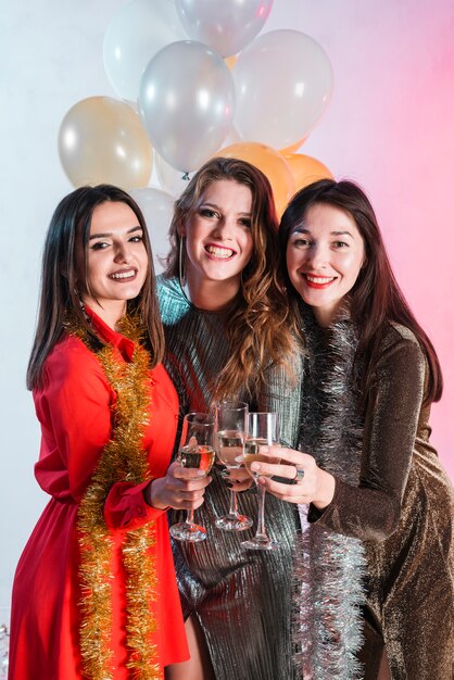 Women holding champagne glasses in hands 