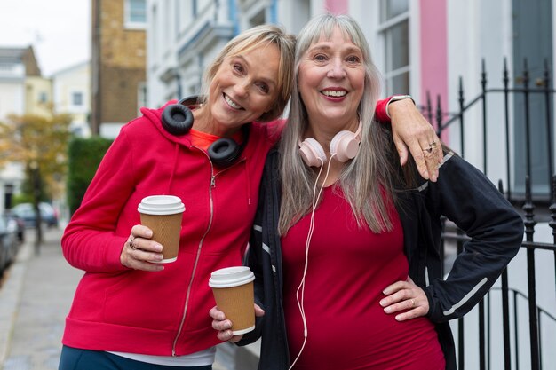 Women holding coffee cups medium shot