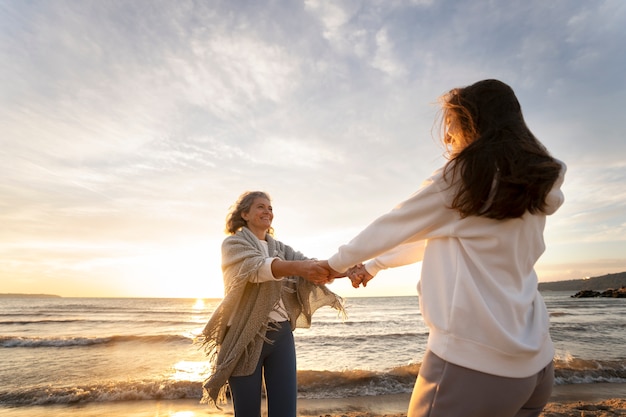 Free photo women holding hands side view