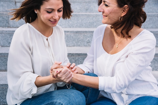 Women holding hands on stairs