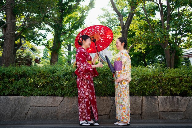 Women holding wagasa umbrella full shot