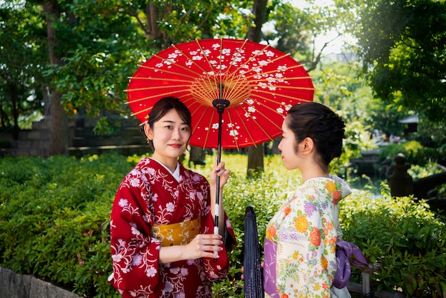 Women holding wagasa umbrella medium shot