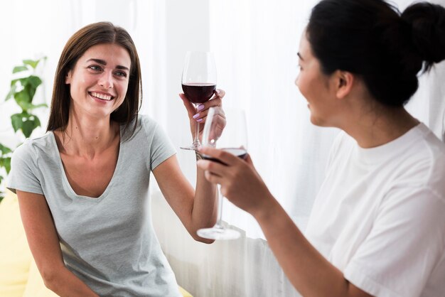 Women at home chatting over wine and dessert