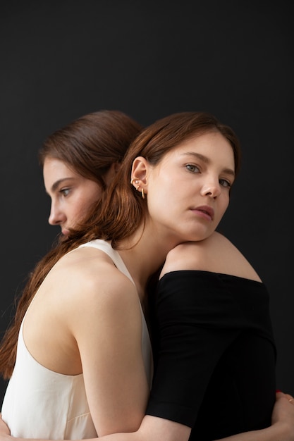 Women hugging in studio side view