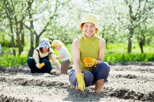 women and kid sows seeds