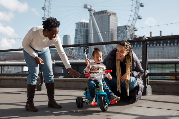 Women and kid with tricycle full shot