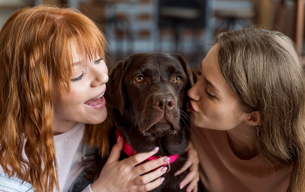 Free photo women kissing dog  close up