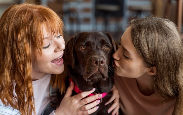 Women kissing dog  close up