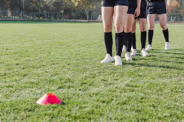 Women legs preparing to run through cones