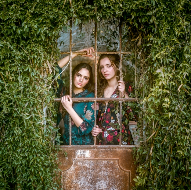 Women looking at camera through bars