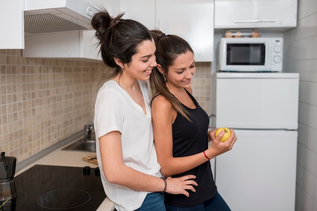 Free photo women in love hugging in kitchen