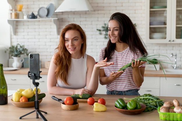 Foto gratuita donne che fanno un vlog mentre preparano il cibo