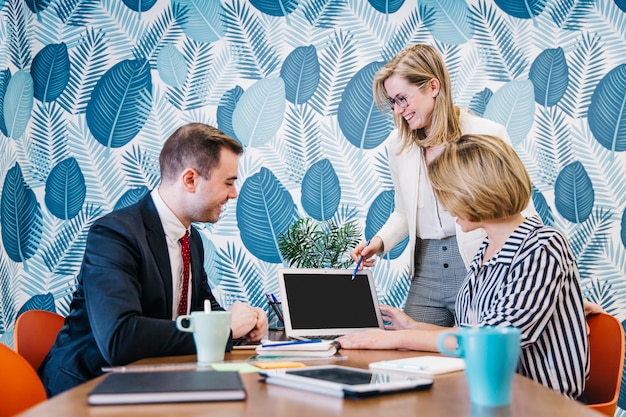 Women and man working at laptop