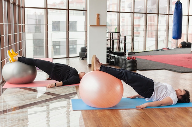 Women on mat working with ball