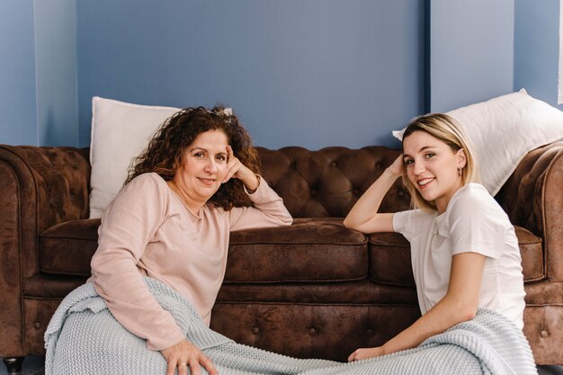 Women near couch looking at camera