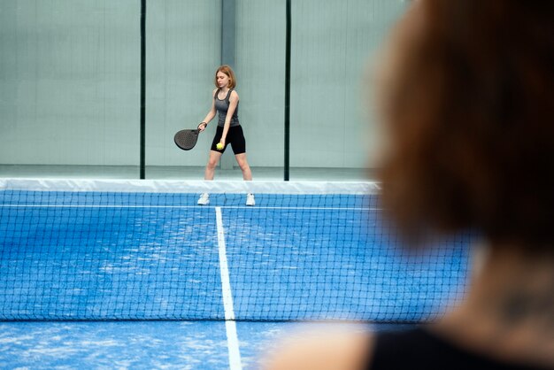 Women playing paddle tennis together