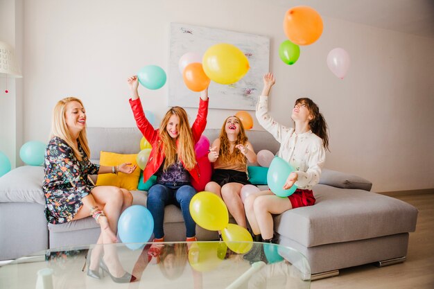 Women playing with balloons