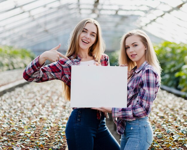 Women pointing at blank sheet